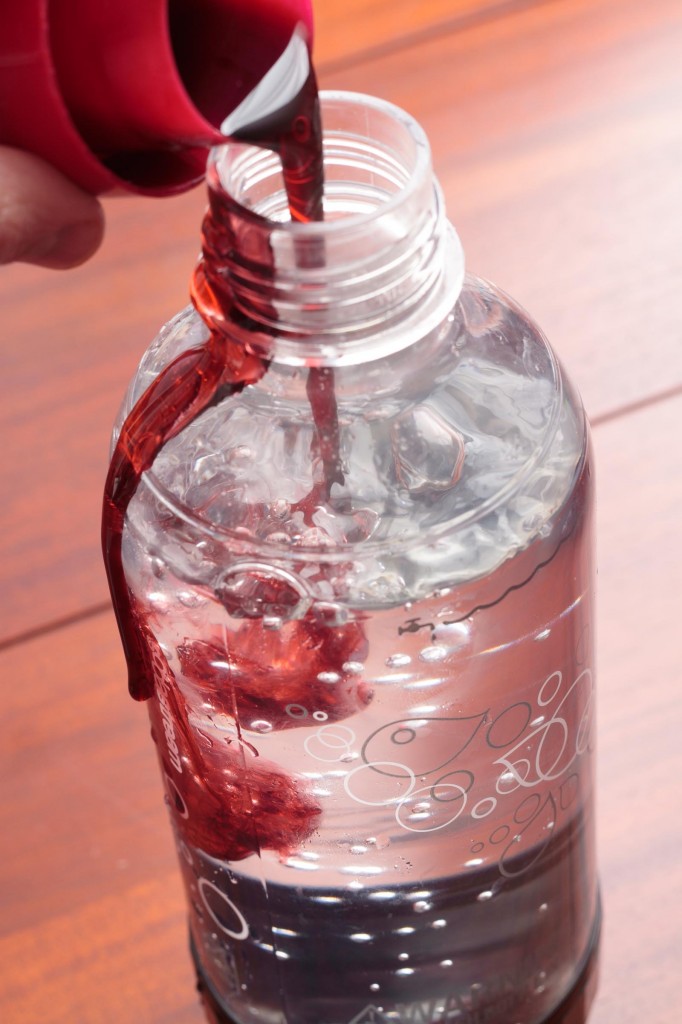 Adding syrup to a bottle of Sodastream seltzer